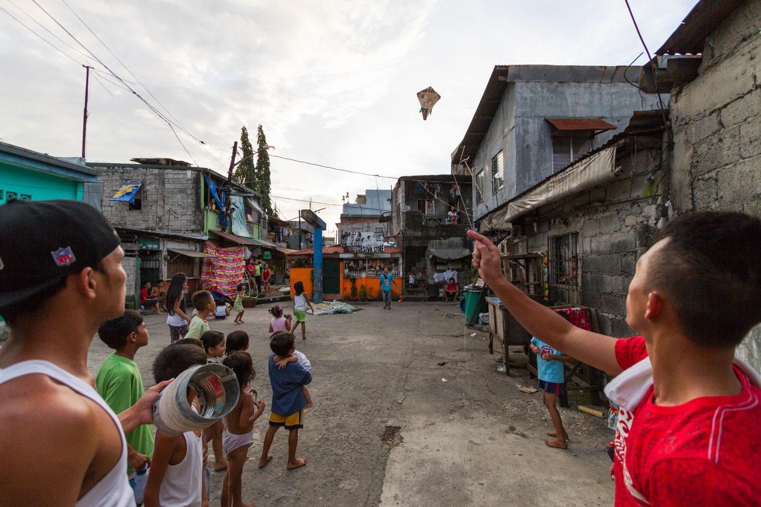 Kites are a very popular activity in the neighborhoods of Philippines. The gangs loves to play it. They glue crushed glass on the string and the goal is to cut opposite gangs kite string.
Dagat Dagaatan, Caloocan, Metro Manila, Philippines - 19/10/2012.